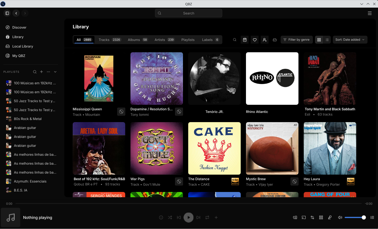 QBZ library showing 2885 items split into 2326 tracks, 58 albums, 239 artists and 6 labels, with the cover grid and the playlist list in the left sidebar