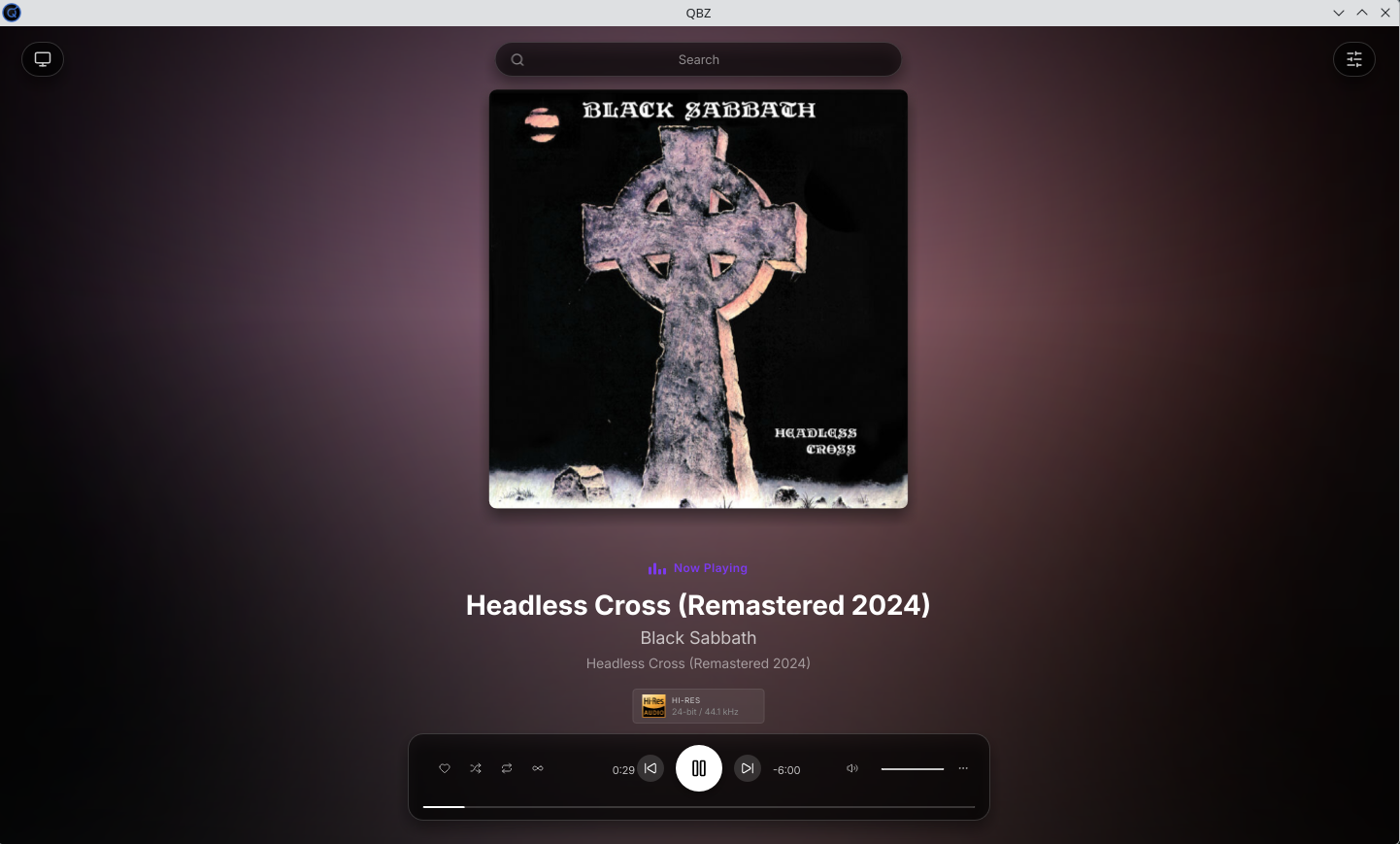 QBZ full-screen Now Playing mode, with the Headless Cross cover enlarged, a gradient background sampled from the artwork, the Hi-Res 24-bit 44.1 kHz badge and centred playback controls